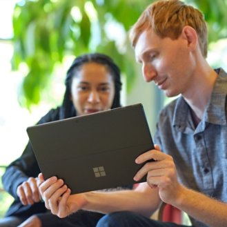 MSFT Two people collaborate while looking at a Surface device RWOjcQ | Braintree