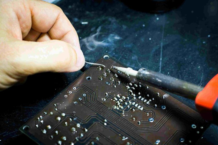 person soldering a chip