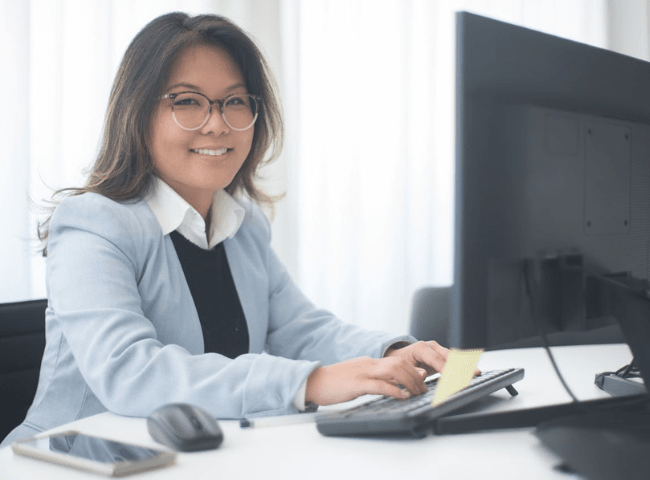 Woman in Gray Blazer Using a Computer