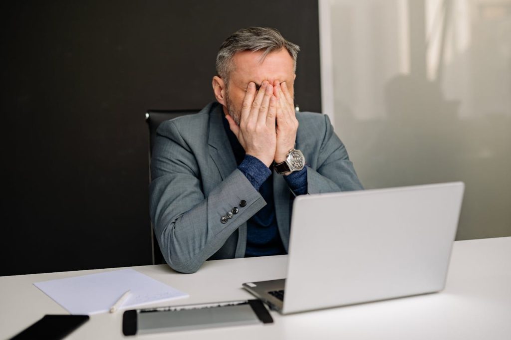 frustrated man with his face in his hands