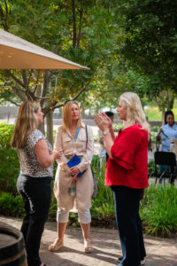 three women conversing outside the Accelerate Action: A Creative Brunch for Women in Business Leadership function