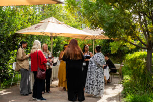 a group of women conversing outside at the Accelerate Action: A Creative Brunch for Women in Business Leadership function