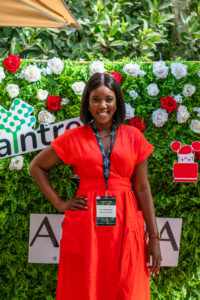 woman in a red dress smiling at the camera at the Accelerate Action: A Creative Brunch for Women in Business Leadership function