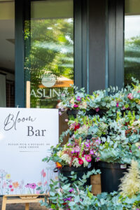 a sign saying "Bloom Bar" in front a door that says "Aslina" at the Accelerate Action: A Creative Brunch for Women in Business Leadership function