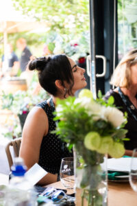 woman listening attentively to an off screen speaker at the Accelerate Action: A Creative Brunch for Women in Business Leadership function