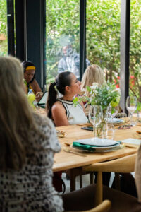 woman looking out a window at the garden outside the Accelerate Action: A Creative Brunch for Women in Business Leadership function