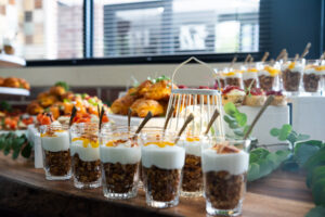 table covered with muesli and yogurt cups, croissants and other breakfast items at the Accelerate Action: A Creative Brunch for Women in Business Leadership function