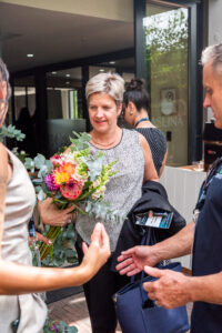 two women and a man conversing outside the Accelerate Action: A Creative Brunch for Women in Business Leadership function
