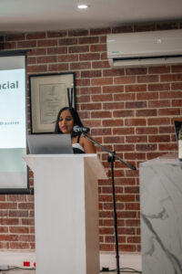 women in a black and white dress speaking at the Accelerate Action: A Creative Brunch for Women in Business Leadership function