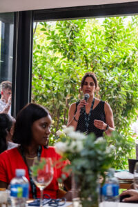 woman in a dotted dress speaking at the Accelerate Action: A Creative Brunch for Women in Business Leadership function