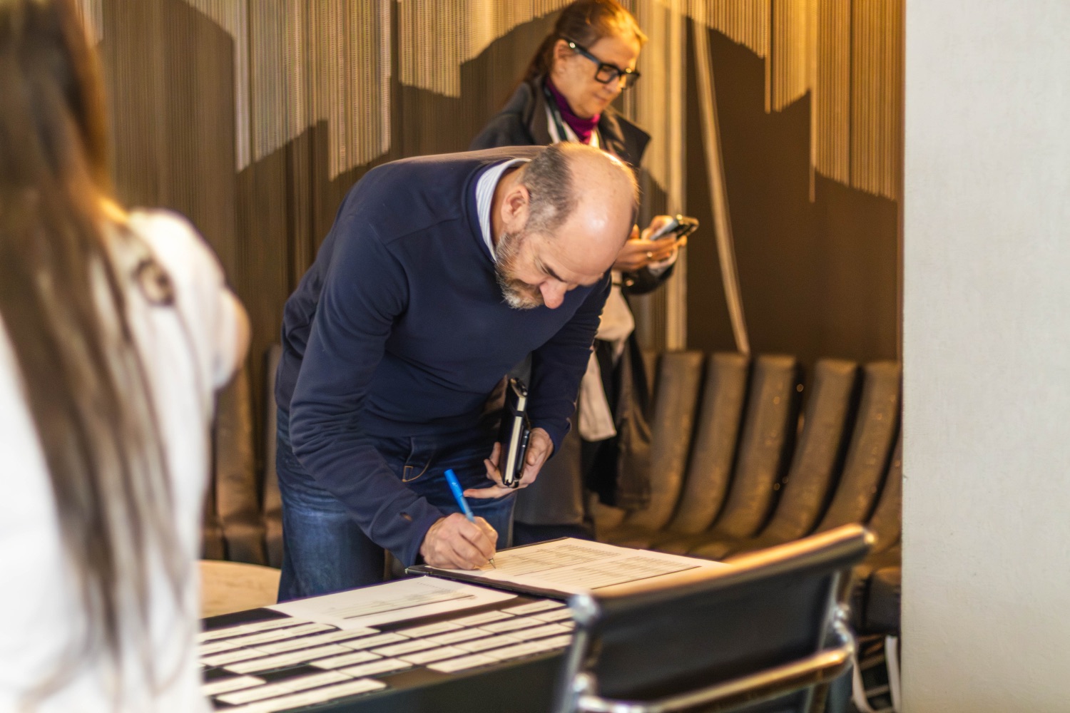A guest signing in at the registration desk