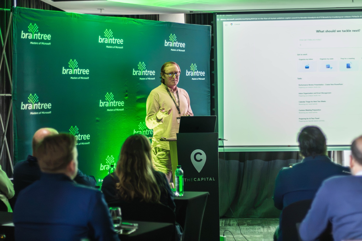 A speaker presenting against the Braintree branded backdrop