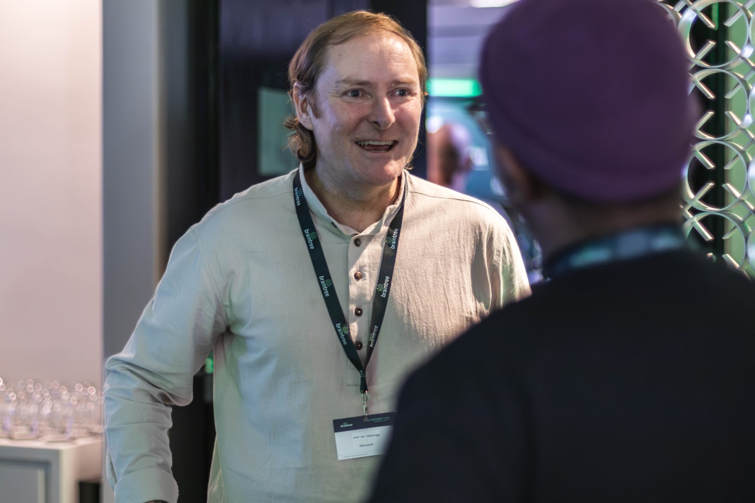 A guest smiling during a conversation at the evening reception