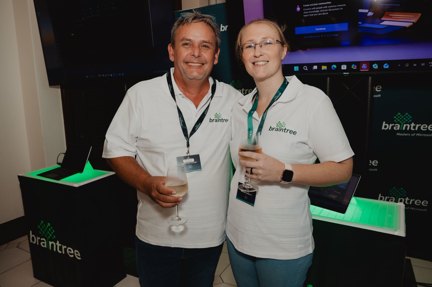 Two colleagues with drinks by the Braintree stand