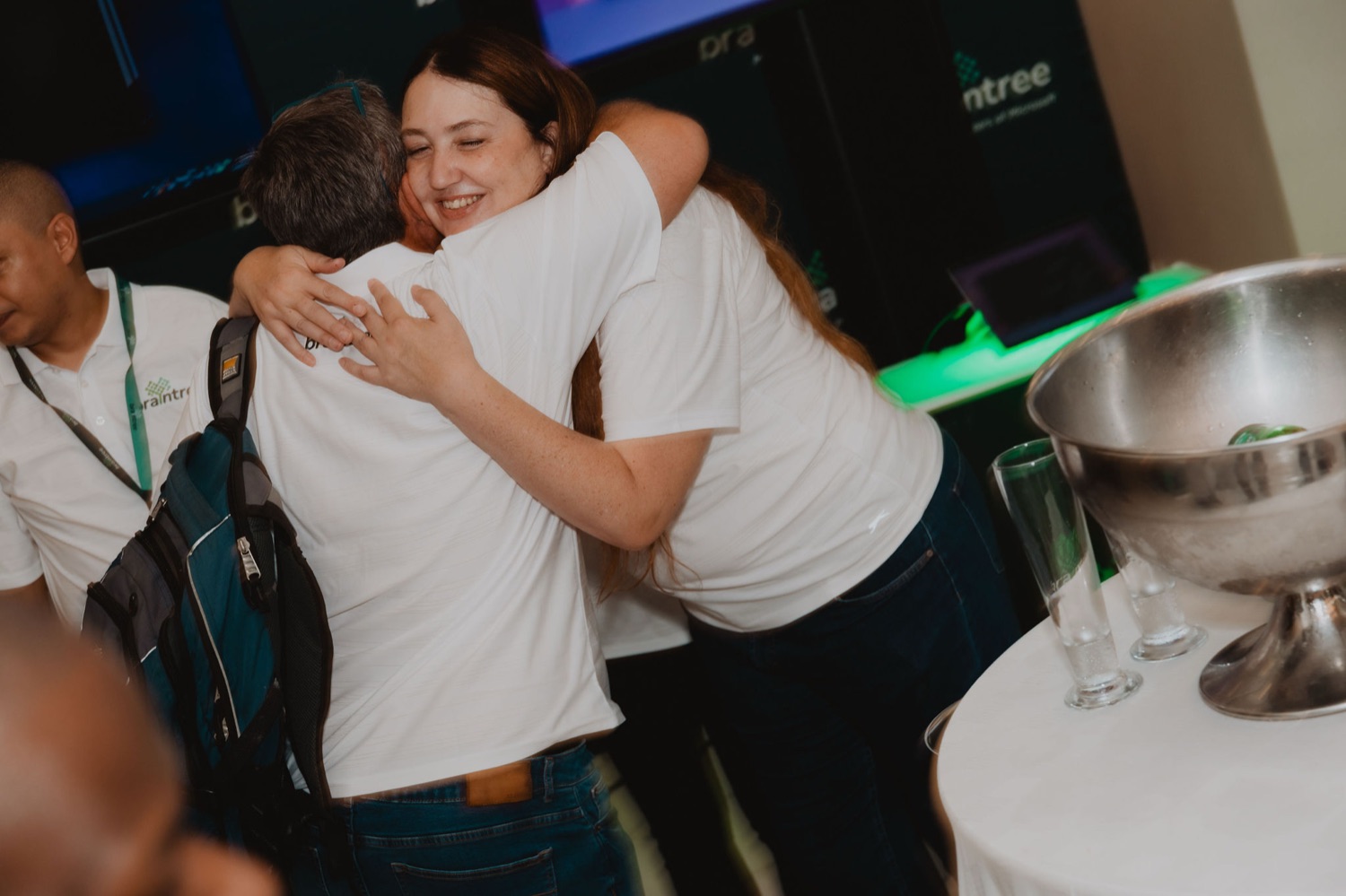 A warm embrace between two guests during the reception