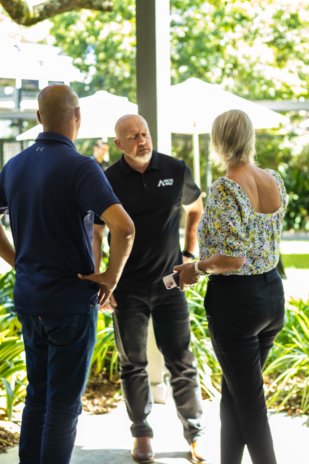 Guests networking in the garden between sessions