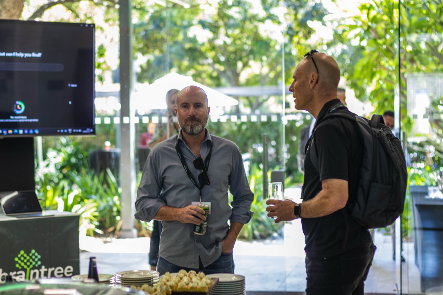 Two guests chatting over drinks at the networking area