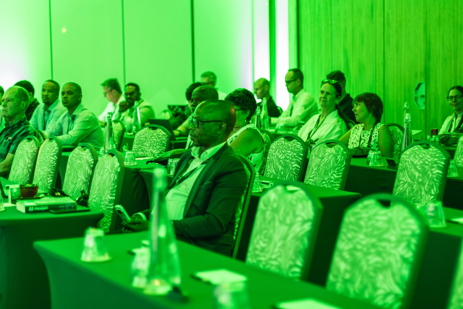 Attendees seated in the audience during a session