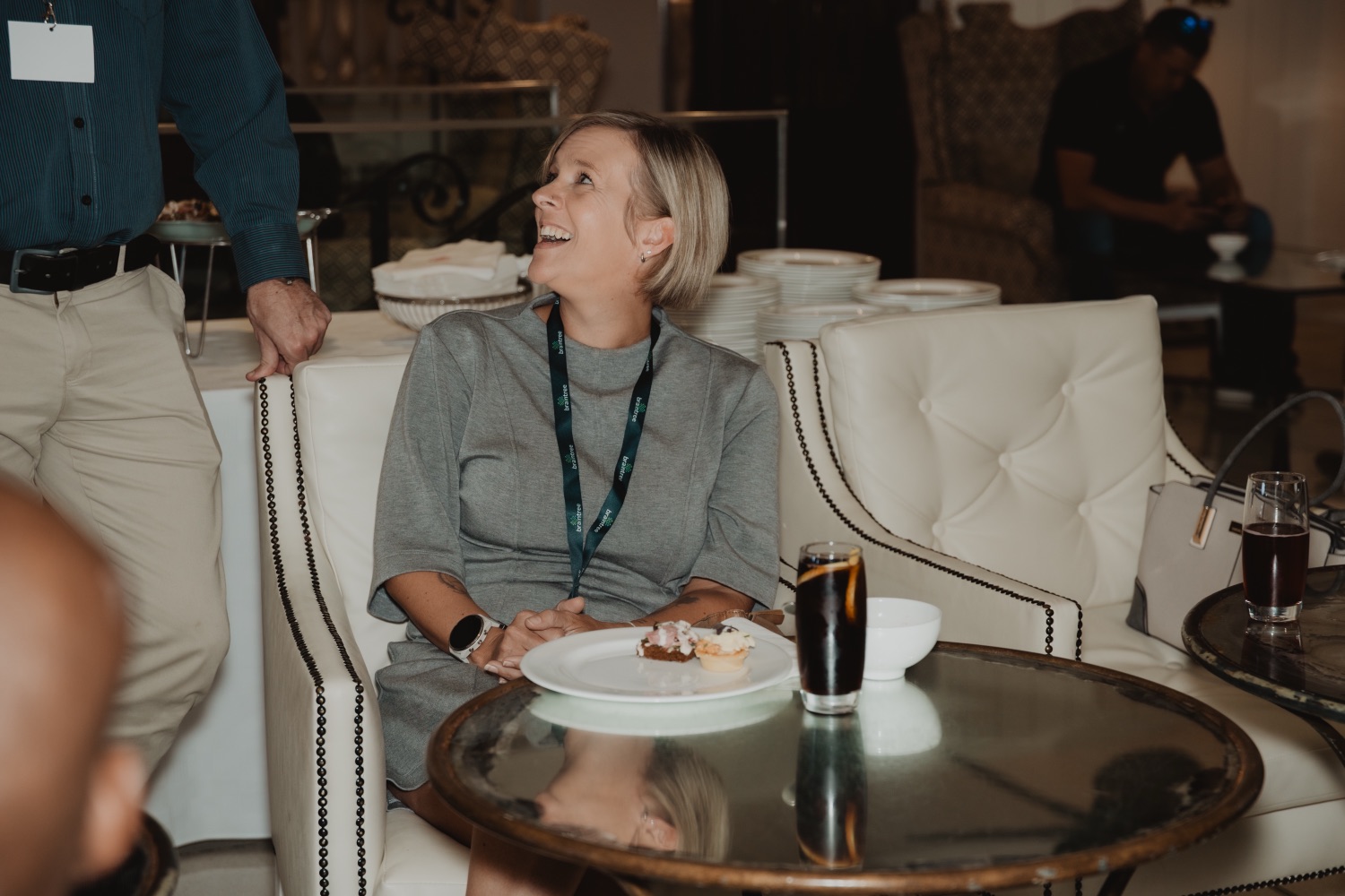 Two guests sharing a laugh over drinks
