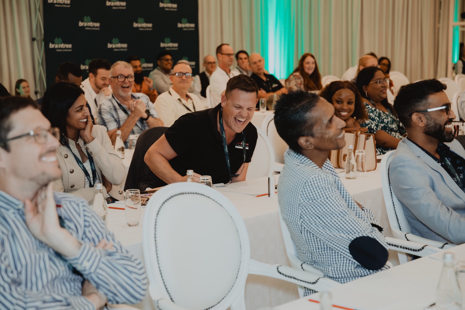 An engaged audience laughing during a session