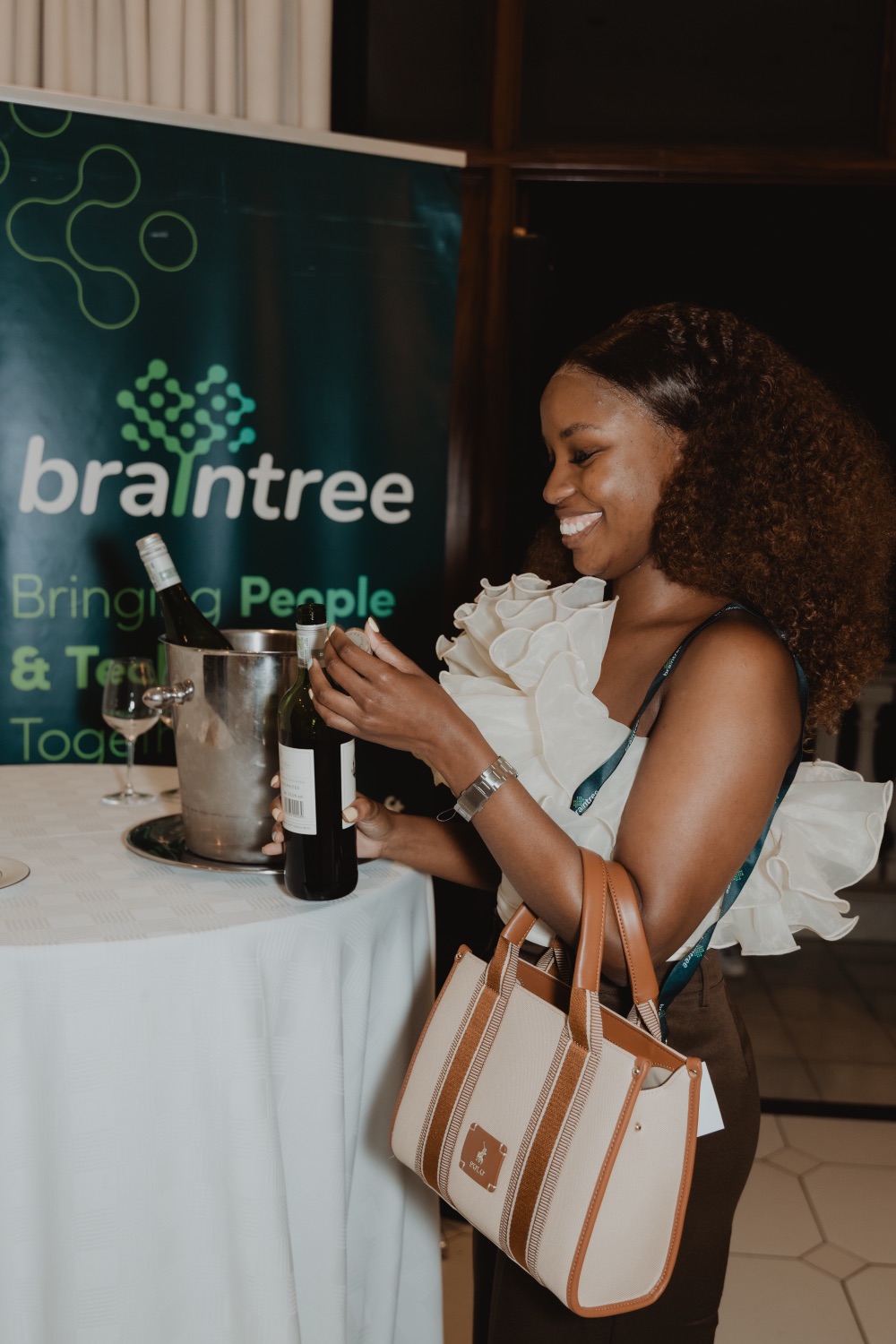 A guest at the drinks station beside a branded banner
