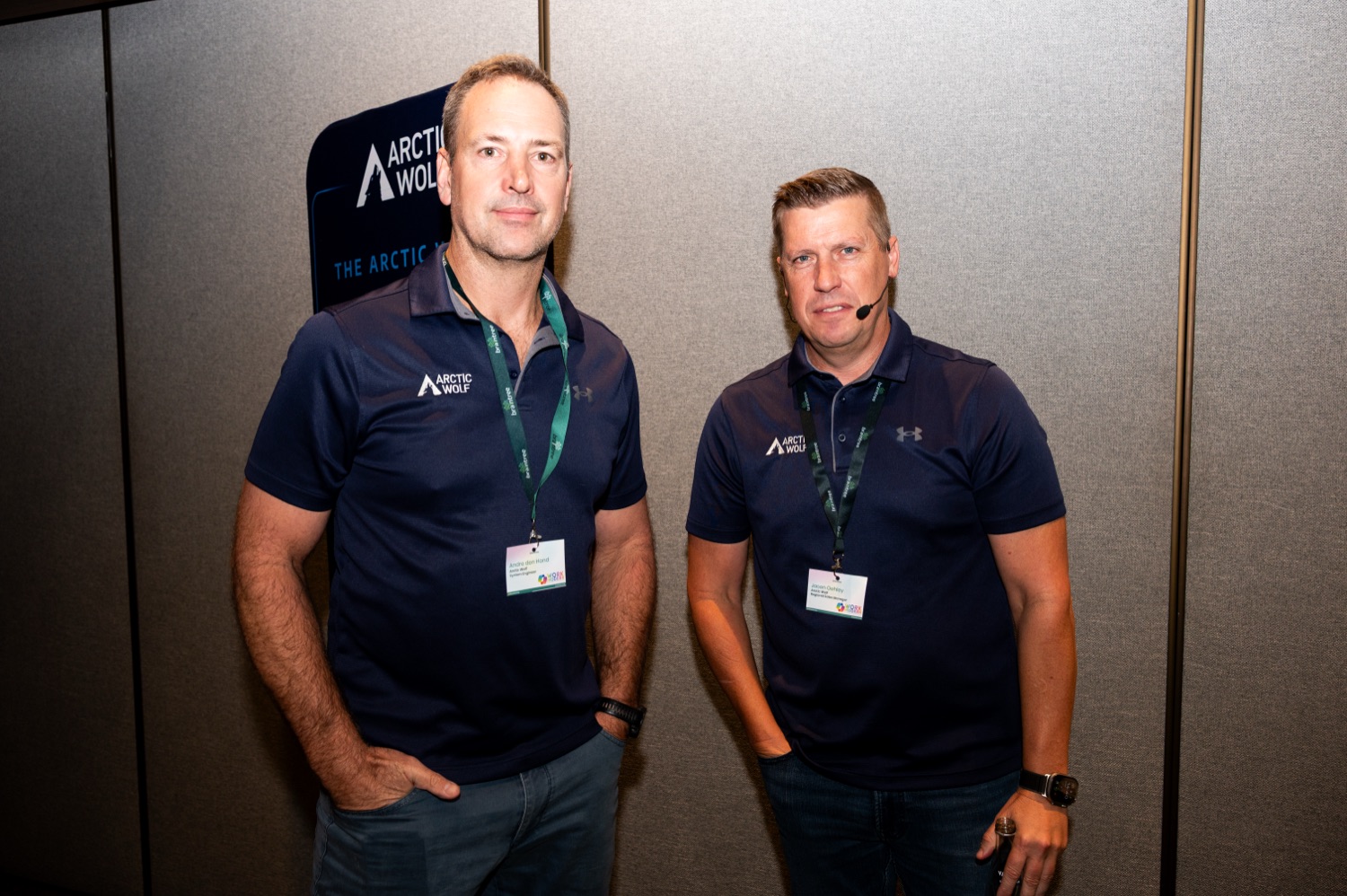 Two Arctic Wolf representatives posing together at the event