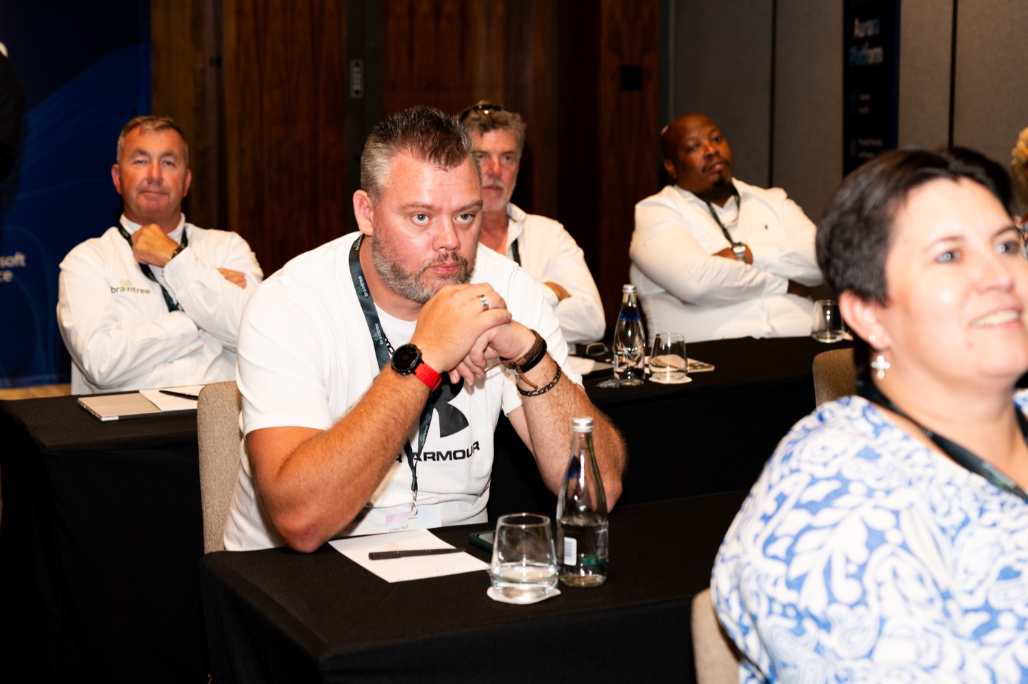 Attendees seated together listening during a session
