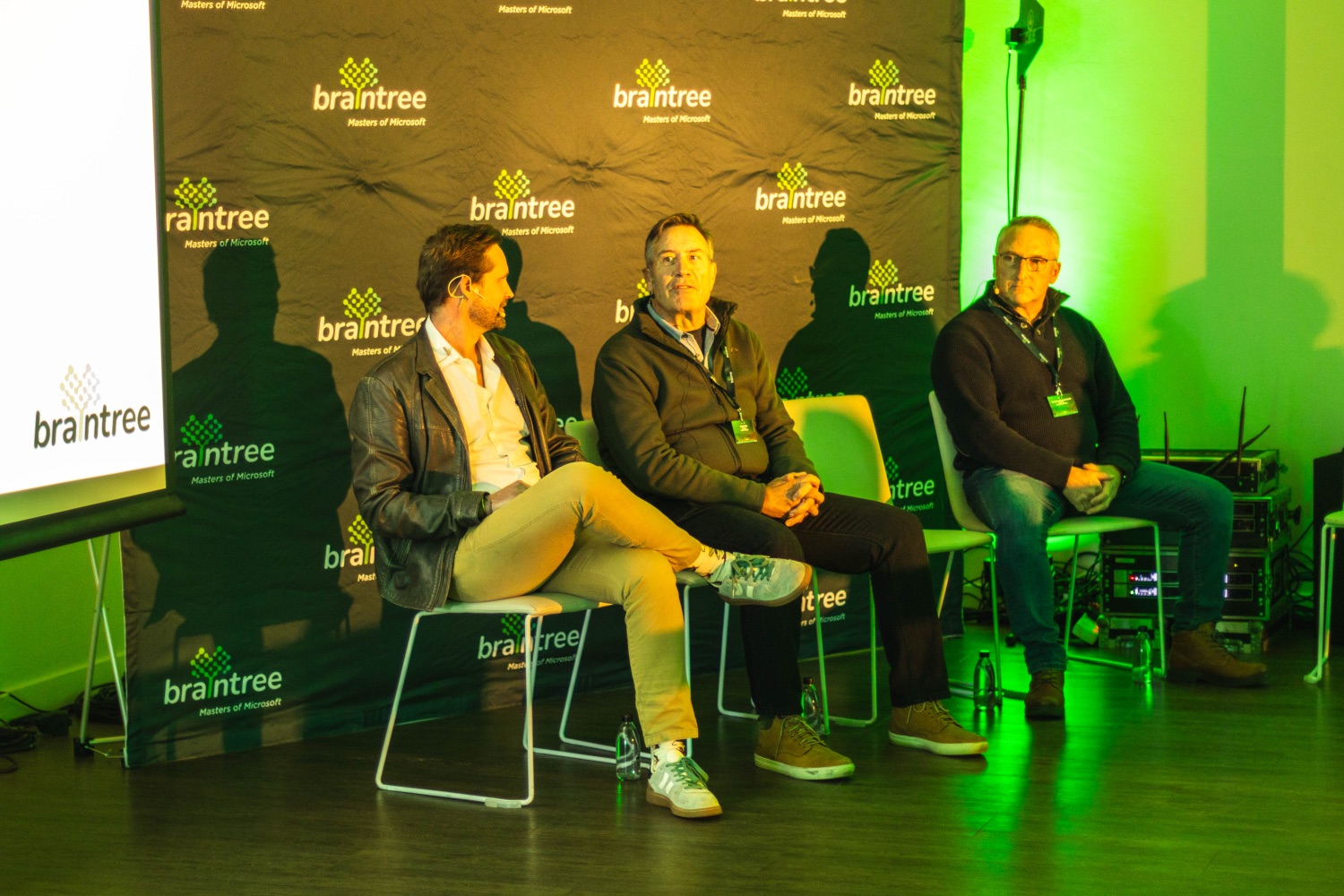 The fireside chat panel seated in front of the Braintree branded backdrop