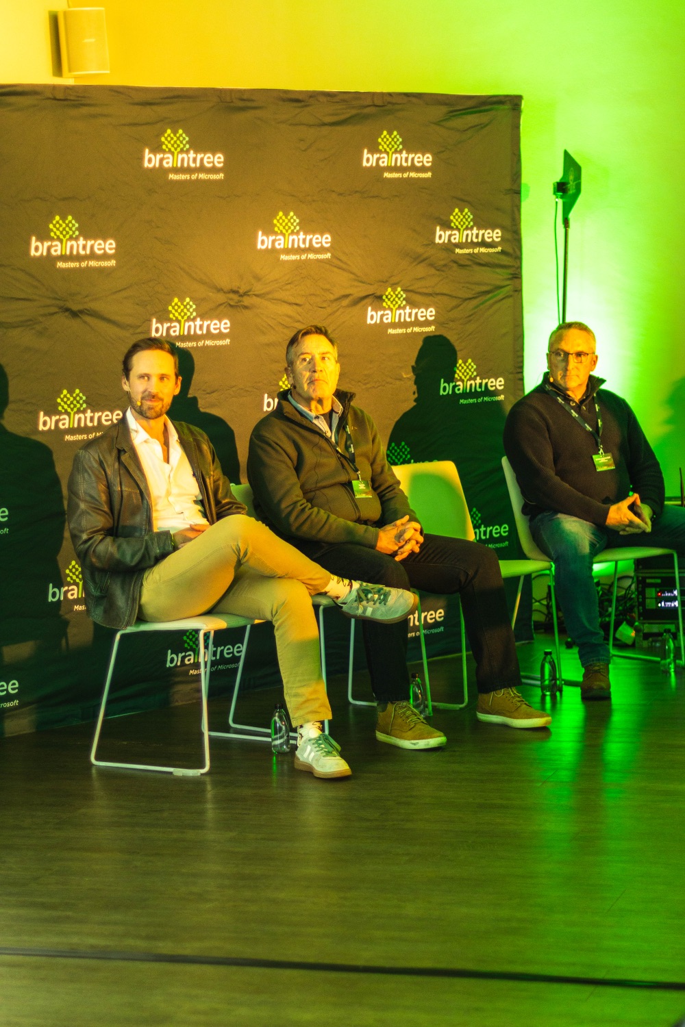 Panellists in conversation on stage against the Braintree backdrop