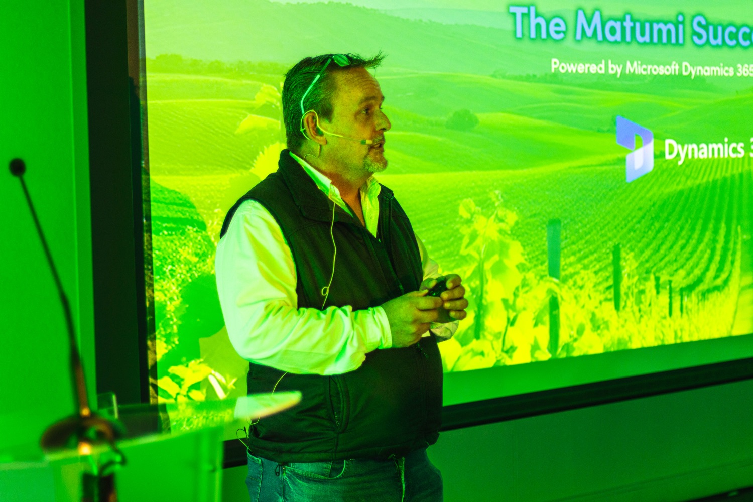 A speaker opens the session in front of the Matumi Success Drive title slide