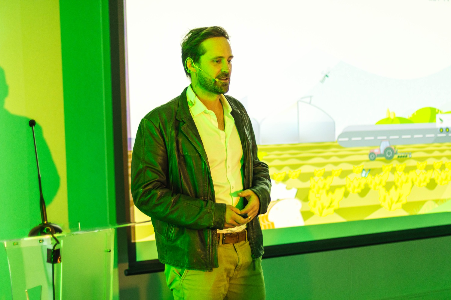 A speaker presents confidently beside the on-screen solution slide