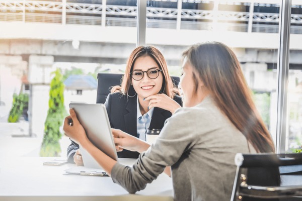 A procurement lead modelling licensing spend at a bright desk