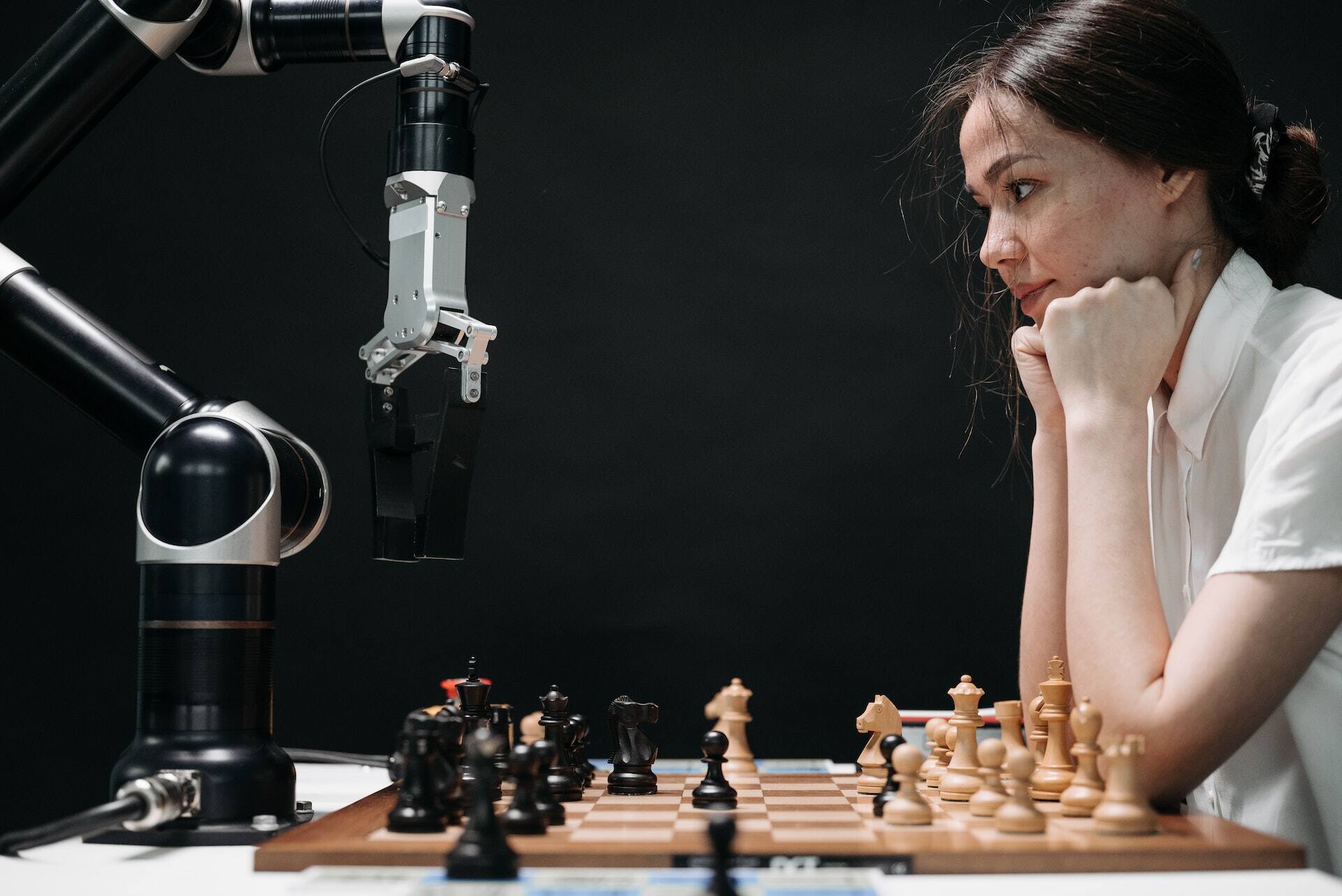 lady playing chess with robot
