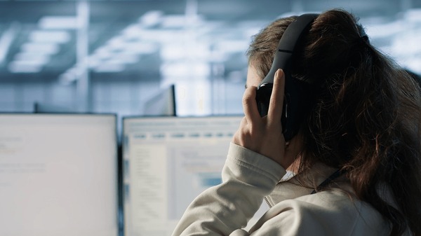 A support engineer settling in at a bright operations desk